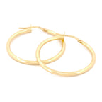 Classic Hoops in Größe XL aus 14k Gelbgold liegen auf weißem Hintergrund.